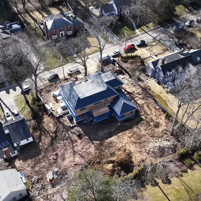Aerial view of a residential construction site with the frame going up